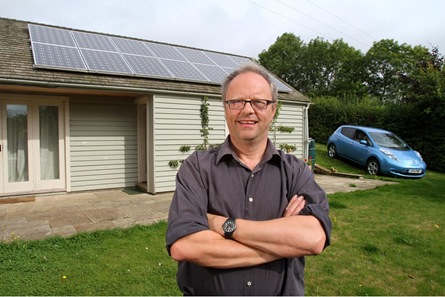 Robert Llewellyn at home with his electric car and solar panels