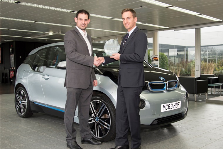 Uwe Dreher, BMW UK's Marketing Director (R), receives the UK Car of the Year 2014 trophy from John Challen, Managing Director of UK Car of the Year, and Editor of ukcoty.co.uk