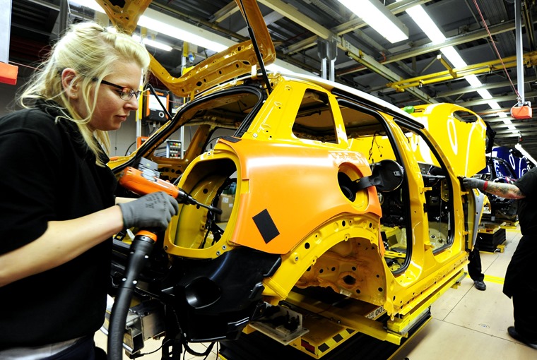 Employees working on the assembly-line at BMW Mini's plant in Coventry