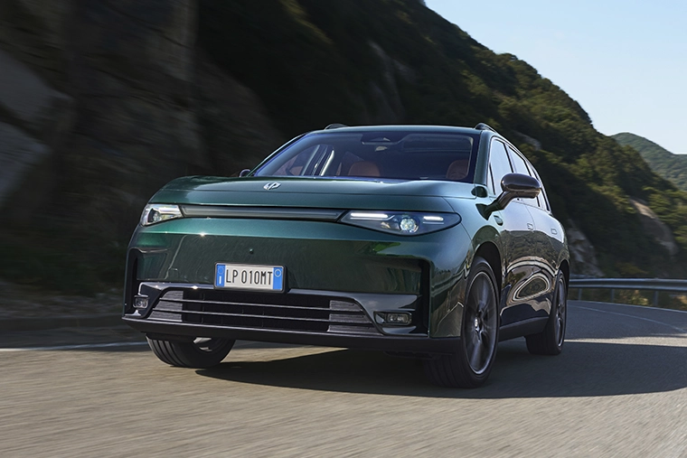 Green Leapmotor electric SUV driving along a winding mountain road, showcasing modern Chinese EV technology, performance and family-friendly design.