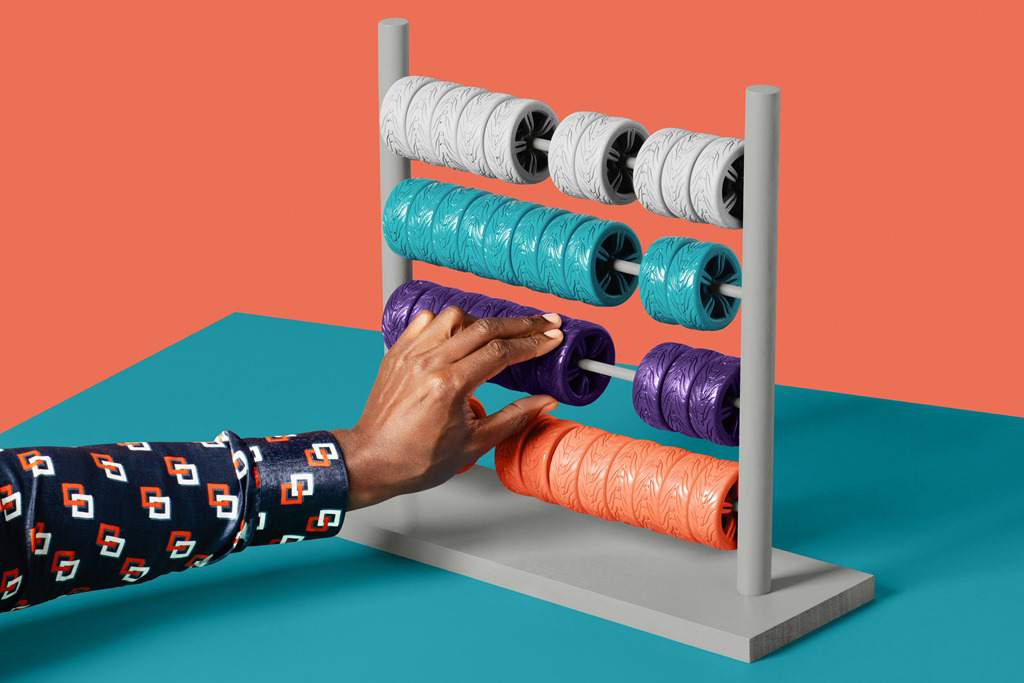 A hand moves a purple wheel on a abacus representing leasing costs.