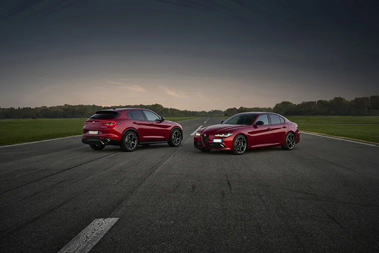 Alfa Romeo Stelvio SUV and Giulia saloon parked on open road