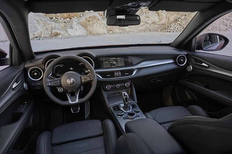 Alfa Romeo interior showing steering wheel, dashboard and infotainment system