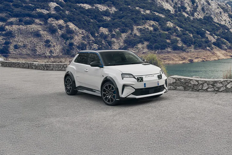 White Alpine A290 electric hot hatch parked by the water