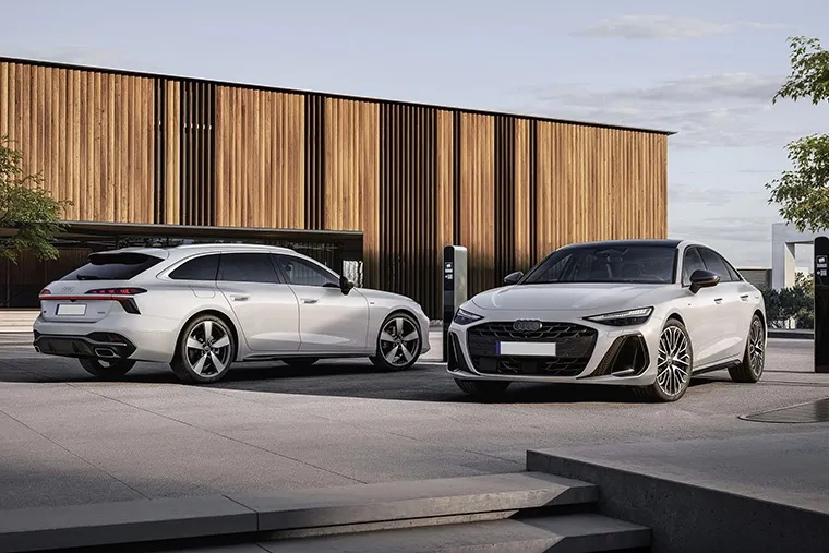 Audi electric range line-up including Q4 Sportback e-tron, e-tron GT, and Q8 e-tron models under vibrant sunset sky.