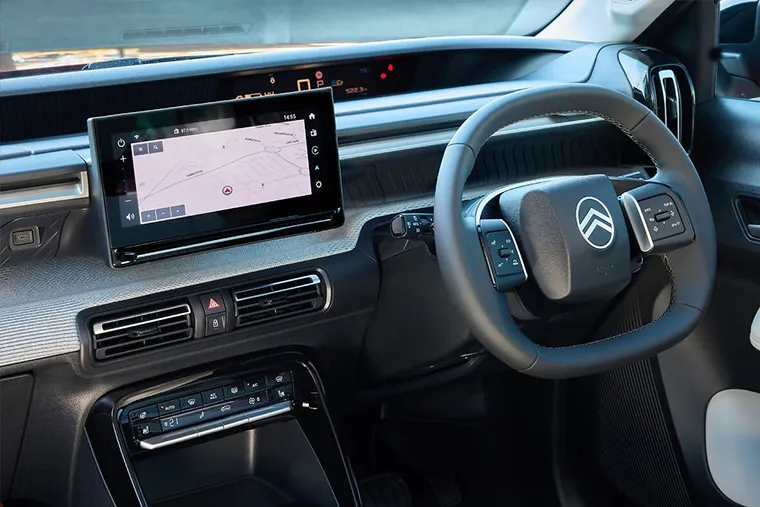Citroen C4 interior featuring digital touchscreen display, navigation system, and multifunction steering wheel.