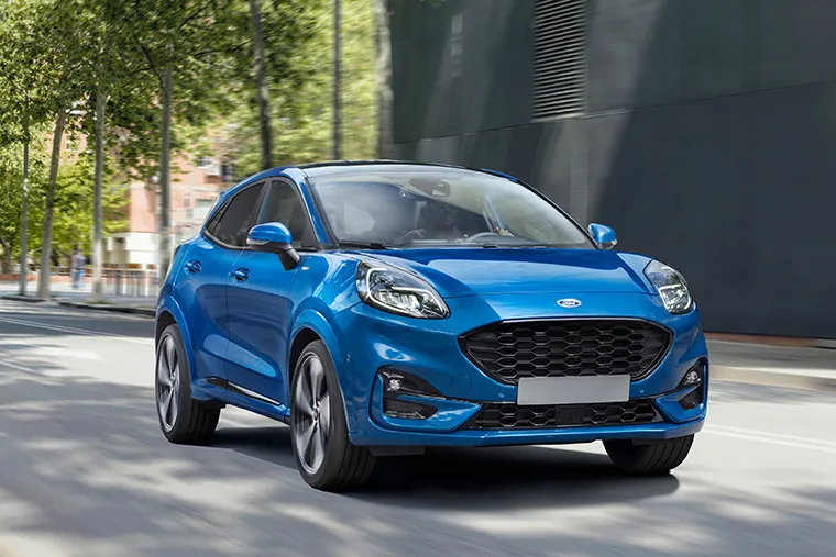 Ford Puma ST-Line in grey, parked on city street, showcasing sporty design under £200 lease deals.