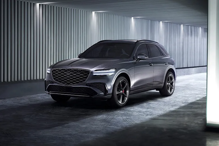 Genesis GV70 luxury SUV front three-quarter view in metallic grey