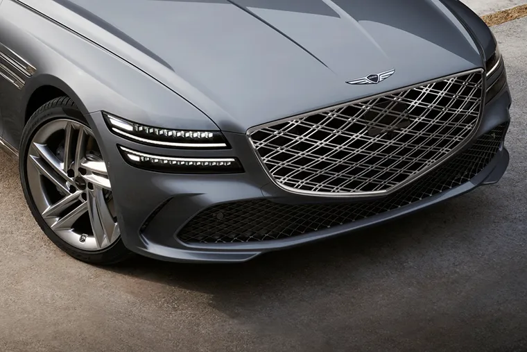 Genesis G80 luxury saloon front grille and headlight close-up