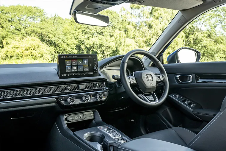 Modern Honda car interior showcasing touchscreen infotainment system, multi-function steering wheel, and digital dashboard