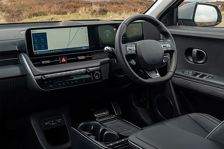 Interior view of a modern Hyundai car showing the digital dashboard, infotainment screen with navigation, and multifunction steering wheel