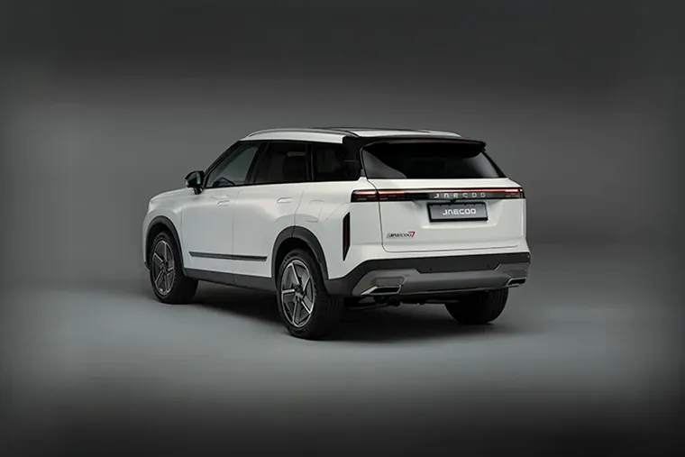 Rear three-quarter view of a white Jaecoo J7 SUV in studio lighting, showcasing modern taillight design and bold rear styling.