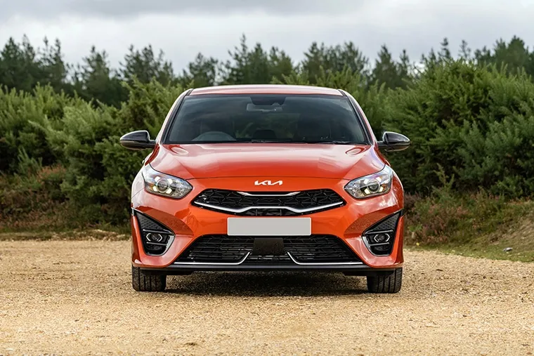 Front view of an orange Kia Ceed, a stylish and affordable hatchback available for under £300 per month on lease..