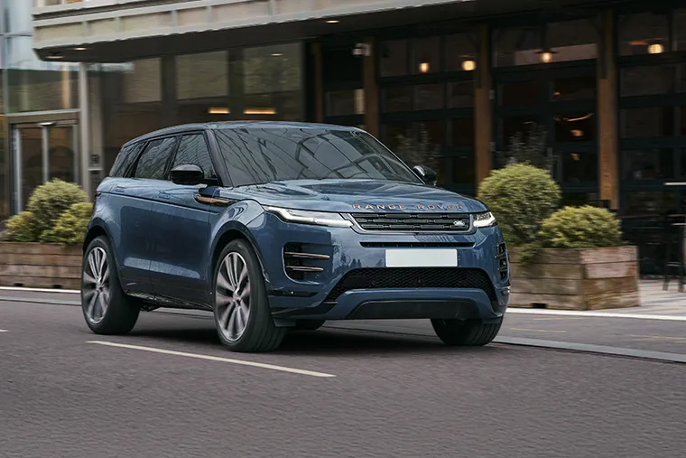 Range Rover Evoque in motion on city road, highlighting premium compact SUV design.