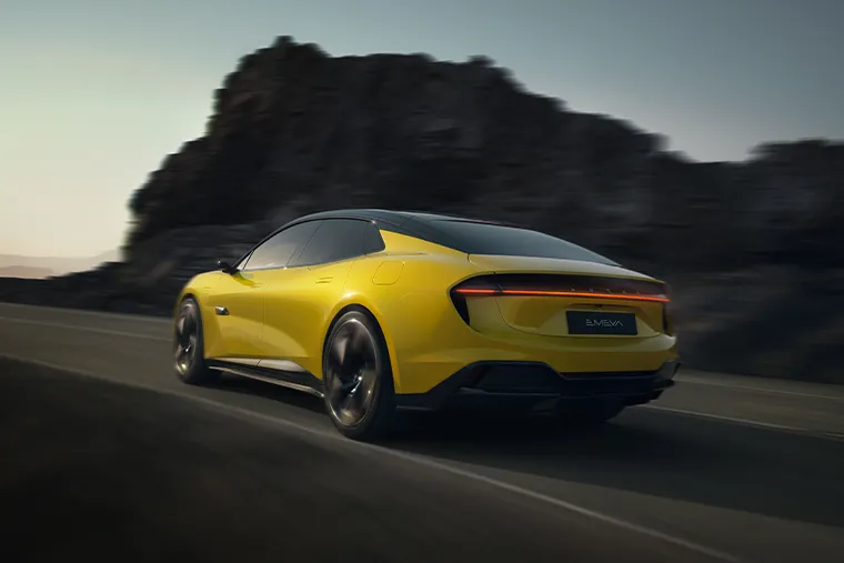 Yellow Lotus Emeya electric hyper-GT driving on mountain road, rear angle view