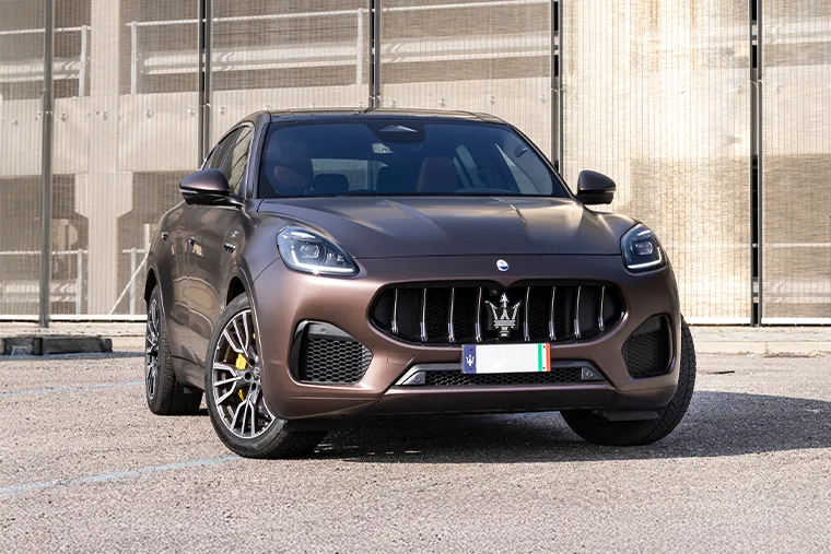 Front view of Maserati Grecale SUV in matte brown finish with signature trident grille