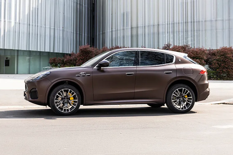 Side profile of brown Maserati Grecale luxury SUV with yellow brake calipers