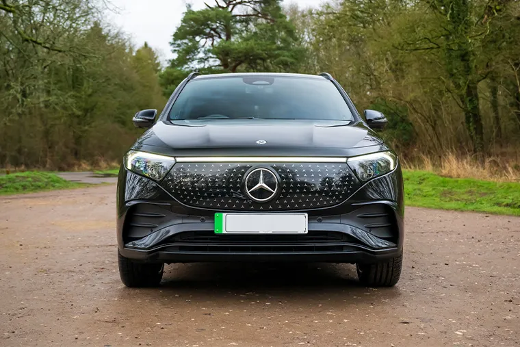Front view of black Mercedes-Benz EQB electric SUV parked on a rural road