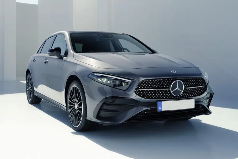 Front three-quarter view of grey Mercedes-Benz A-Class hatchback parked in a bright studio setting