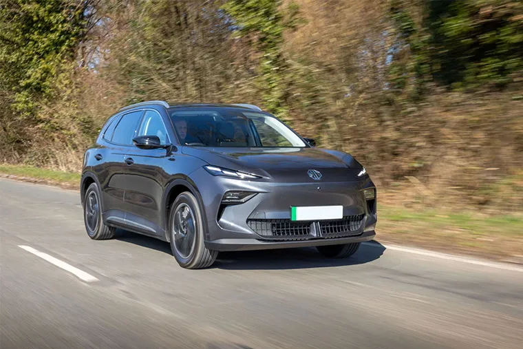 Front view of MG4 EV SUV in grey driving on a countryside road