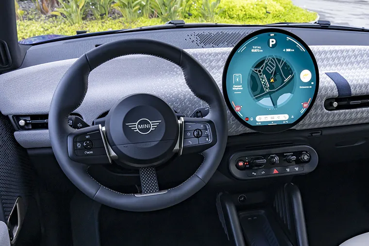 Interior of a MINI Electric showing the round digital dashboard display.