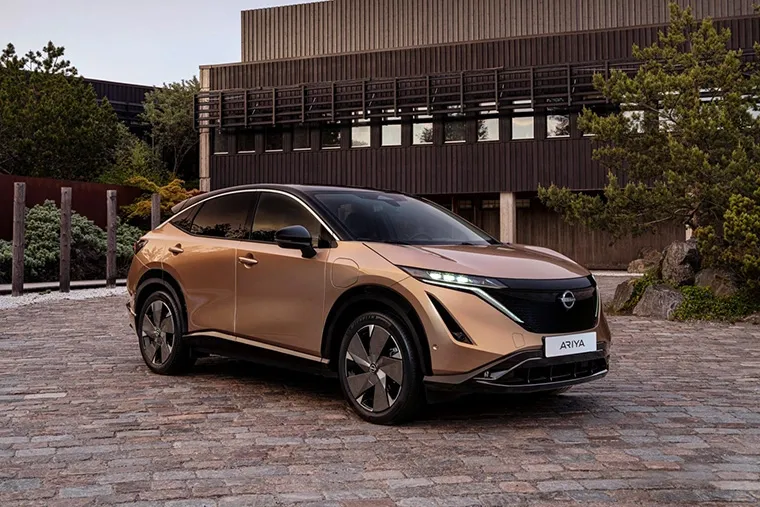 All-electric Nissan Ariya in copper parked in architectural setting