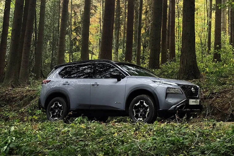Nissan X-Trail e-POWER SUV off-roading through dense woodland