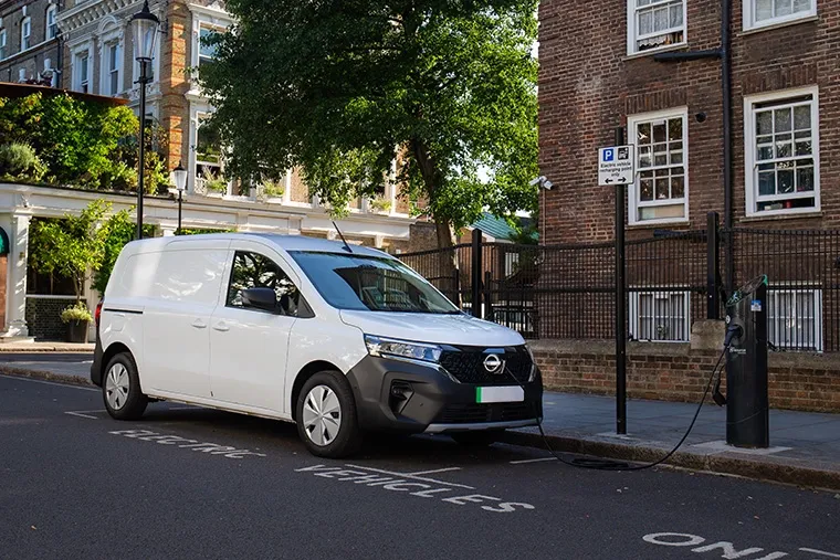 Electric Nissan Townstar van charging on street in residential London