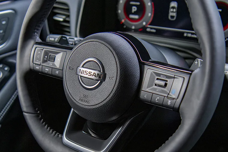 Close-up of Nissan steering wheel and digital driver display