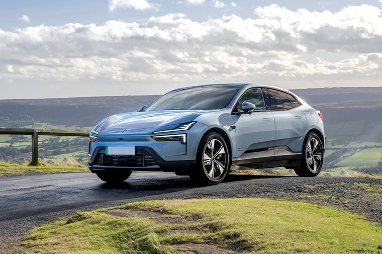 Front view of the Polestar 4 electric SUV driving through a modern urban landscape.