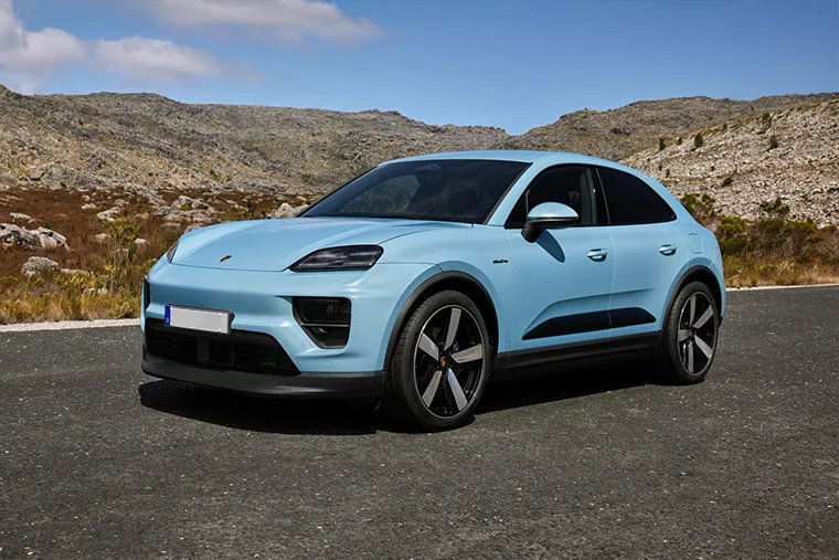 Electric Porsche Macan parked on scenic mountain road