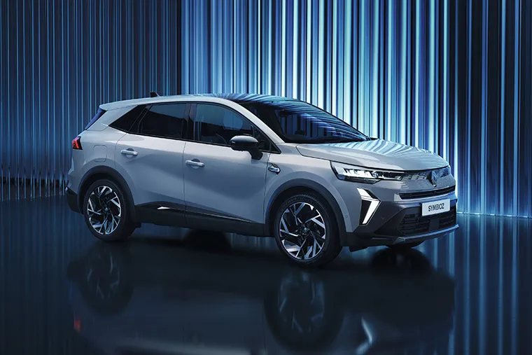 Renault Symbioz electric SUV displayed in futuristic studio with blue ambient lighting.