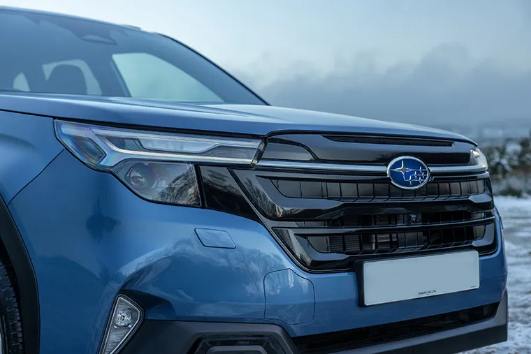 Close-up of 2025 Subaru Forester front grille and LED headlights with Subaru badge