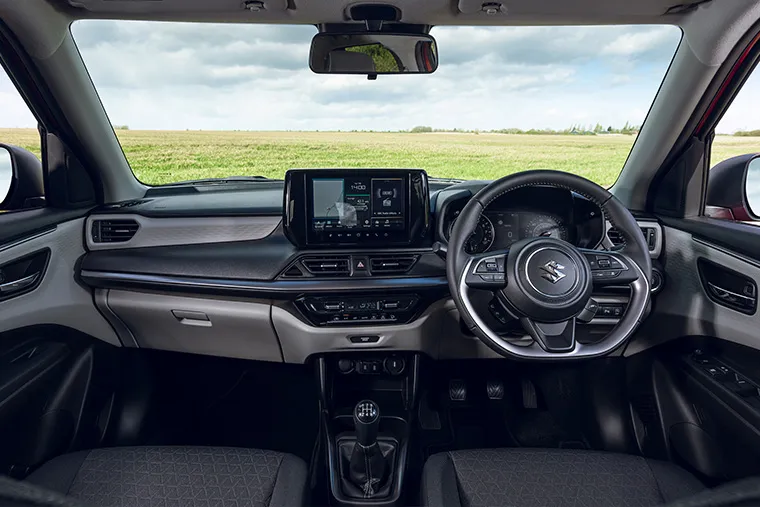 Modern interior of Suzuki Swift Hybrid Ultra featuring touchscreen infotainment and multifunction steering wheel.